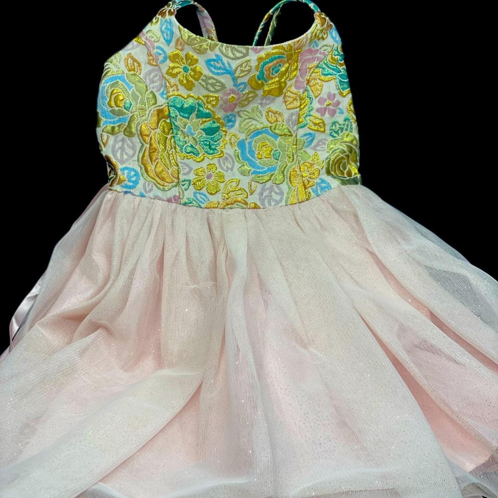 Formal pink dress with a shimmery floral detail.